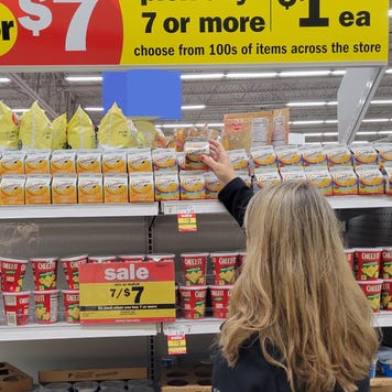 Someone shopping a sale rack at a grocery store