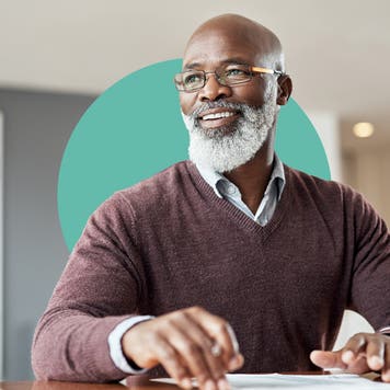 Man typing on a computer, looking happy