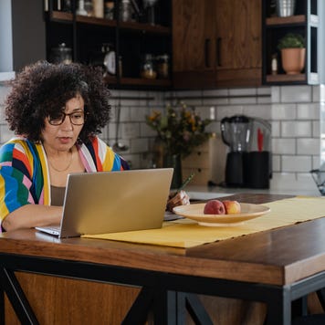 woman using laptop in the kitchen