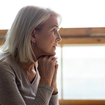 Upset mature woman look in distance feeling sad mourning