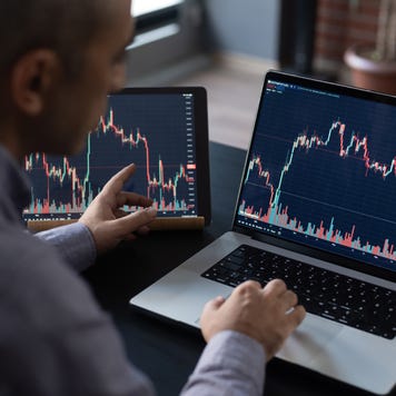 Man Checking His Stock Market Exchange Investment Using His Laptop Computer