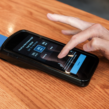 Man Pays Bill at Restaurant With Credit Card on Wireless Device