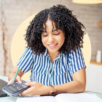Woman looks at calculator