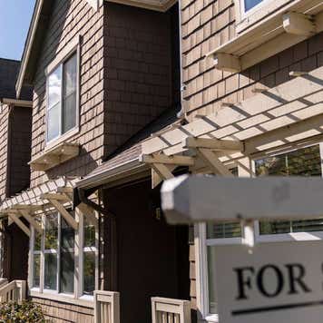 A For Sale sign in front of a home