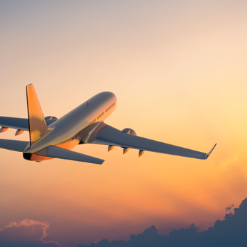 Passanger airplane flying above clouds in evening.