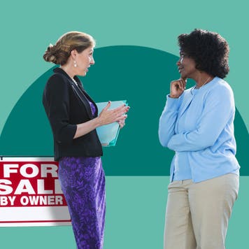 Two women chatting in front of a for sale sign