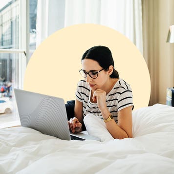 design image depicting a woman laying on her bed on her laptop
