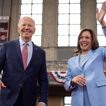 U.S. President Joe Biden and U.S. Vice President Kamala Harris wave to members of the audience.