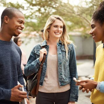 Friends chatting on a university campus.