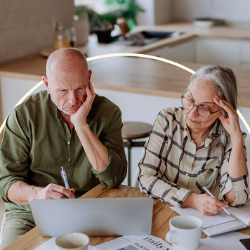 Couple looking at a laptop.