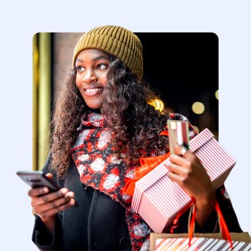 Young Black woman shopping and holding credit card