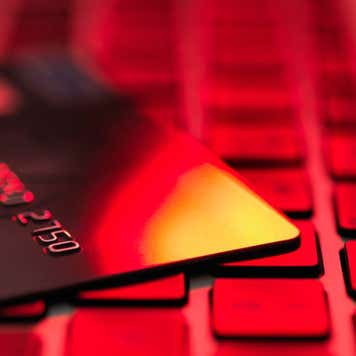 Credit card sitting on a laptop.