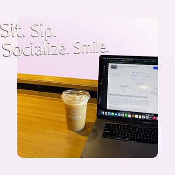 Design element of a coffee sitting next to a laptop.