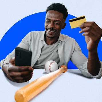 Design element of a man holding a credit card and a cell phone smiling