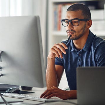Cropped shot of a businessman using his computer in his home office