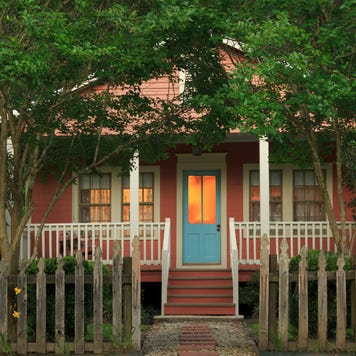 Cottage with weathered picket fence at twilight