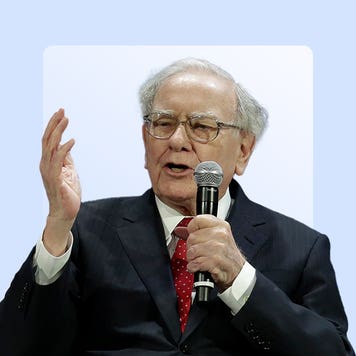 Warren Buffett holding a microphone.