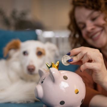 Woman saving money in a piggy bank