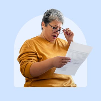 A woman looking at a sheet of paper
