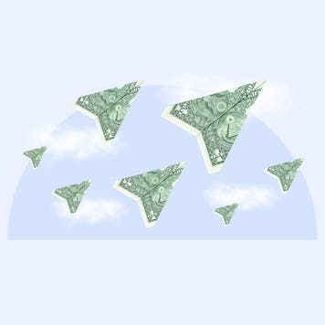 American dollar bills in the shape of paper airplanes on a background of clouds