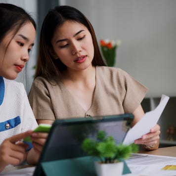 Two women reviewing documents at a table
