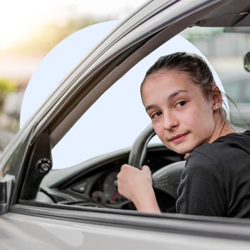 Person driving a car and looking back as they back up