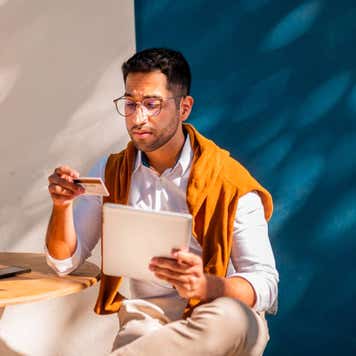 A young man paying online with his credit card