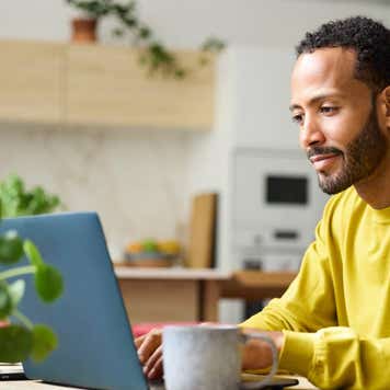 A man works on his laptop.
