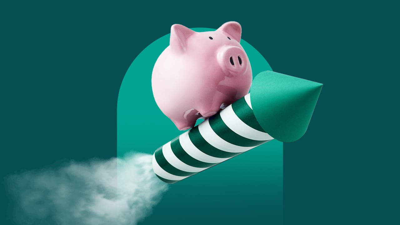An image of a pink piggy bank standing on top of a green and white striped rocket with smoke coming out of the end of the rocket.