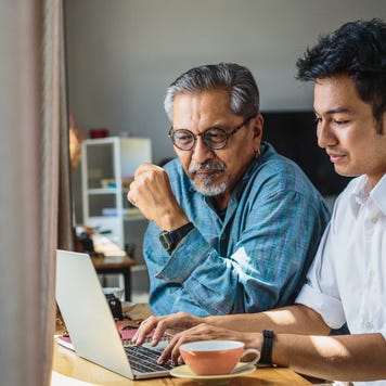 Father and son looking at laptop