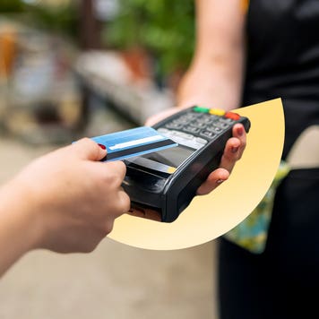 Person paying with a credit card through a handheld terminal