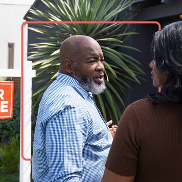 couple outside a home that's for sale, about to go inside and look around