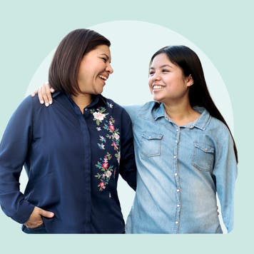 A mother and daughter with their arms around each other