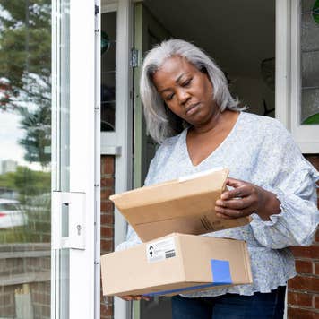 Woman at home receiving some packages and looking confused