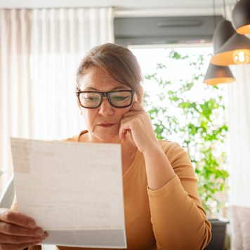 Woman looking at bills.