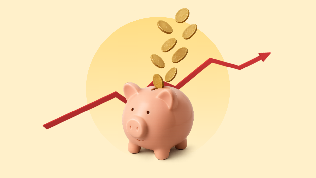 A graphic with a pale yellow background and a darker yellow circle in the center. There is a red line trending up and to the right, with a piggy bank that has coins falling into it in front of that.