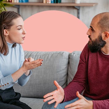 2 people sitting on a couch having a conversation