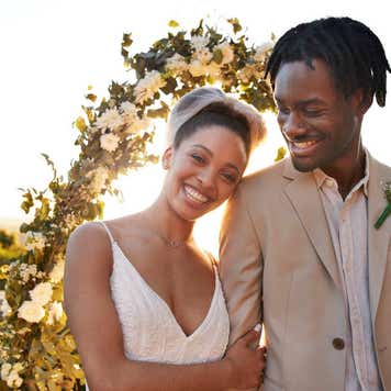 A happy couple smiles on their wedding day.