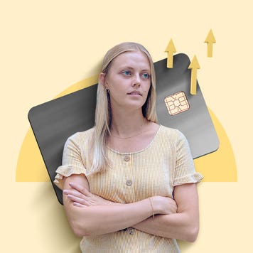 Woman looks off into distance on a background of a credit card