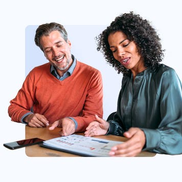 Design element of 2 people sitting at a desk going over financial records