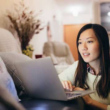 person looking at computer screen in home