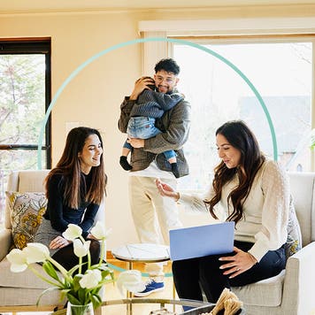 Design element of a family sitting with a real estate agent looking at a laptop