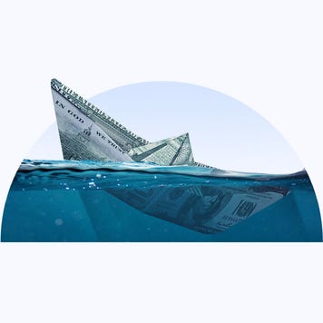A semi-circle image containing a paper boat made of money sinking in water.