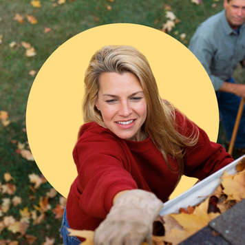 Person cleaning gutter