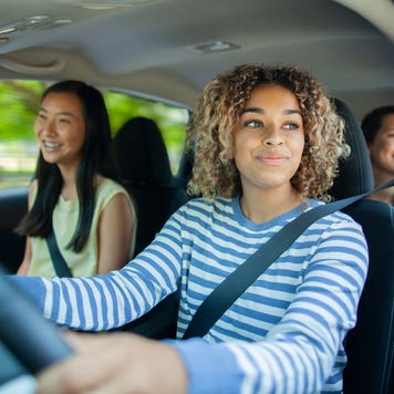 teenage girl driving with her teenage friends as passengers