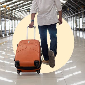 Man pulls a suitcase through an airport