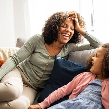 Mother and daughter having fun in the living room