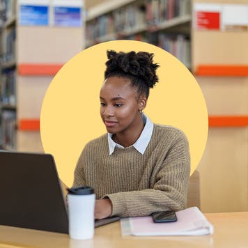 woman working on her laptop in the library