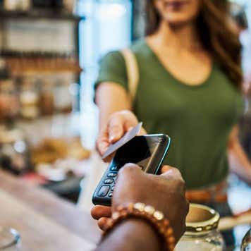 Cashier helping a customer pay in a grocery store