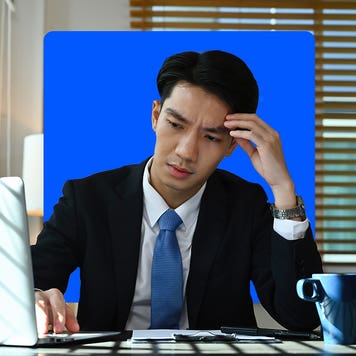 photo illustration of worried man in suit looking at laptop screen